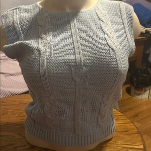 Light blue cable-knit vest. Crew neck,ribbed hem, & front cable-knit pattern.